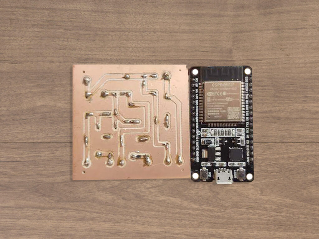 Energy monitor PCB next to ESP32 microcontroller soldered and connected